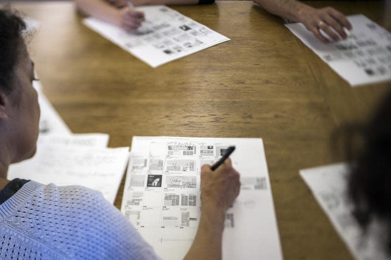 Journalists and editors work during a meeting at the French daily newspaper Liberation, on September 3, 2013 in Paris