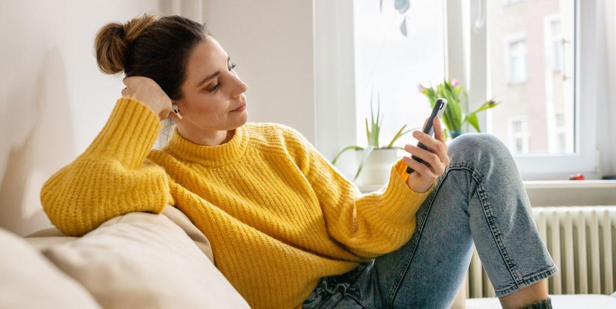 woman listening to relaxation audio from mobile app