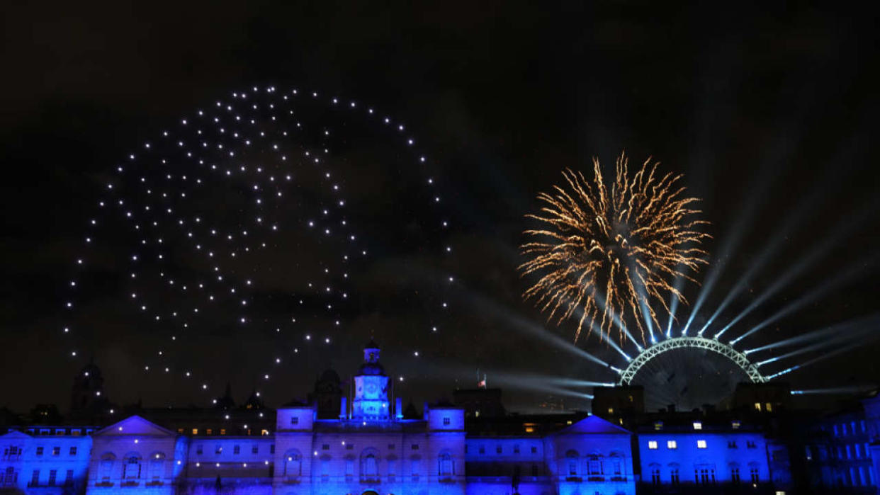 LONDON, ENGLAND - JANUARY 1: Fireworks and a drone show paying tribute to the late Queen Queen Elizabeth II light up the London skyline to celebrate the New Year on January 1, 2023 in London, England. London's New Years' Eve firework display returned this year after it was cancelled during the Covid Pandemic. (Photo by Carl Court/Getty Images)