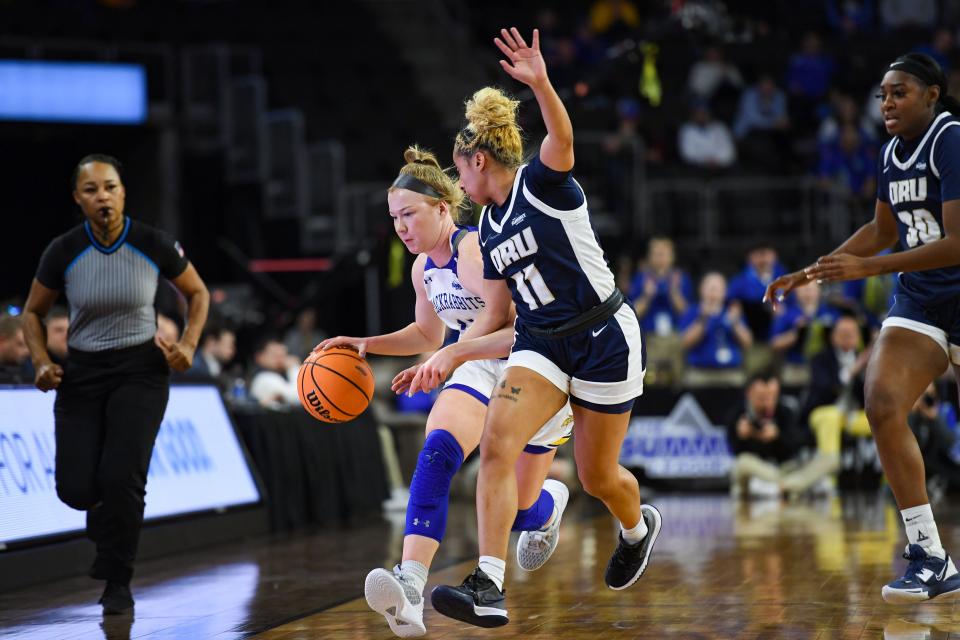 South Dakota State’s Haleigh Timmer attempt to stay in bounds, guarded by Oral Roberts’ Ariel Walker in the Summit League women’s semifinals on Monday, March 6, 2023, at the Denny Sanford Premier Center in Sioux Falls.