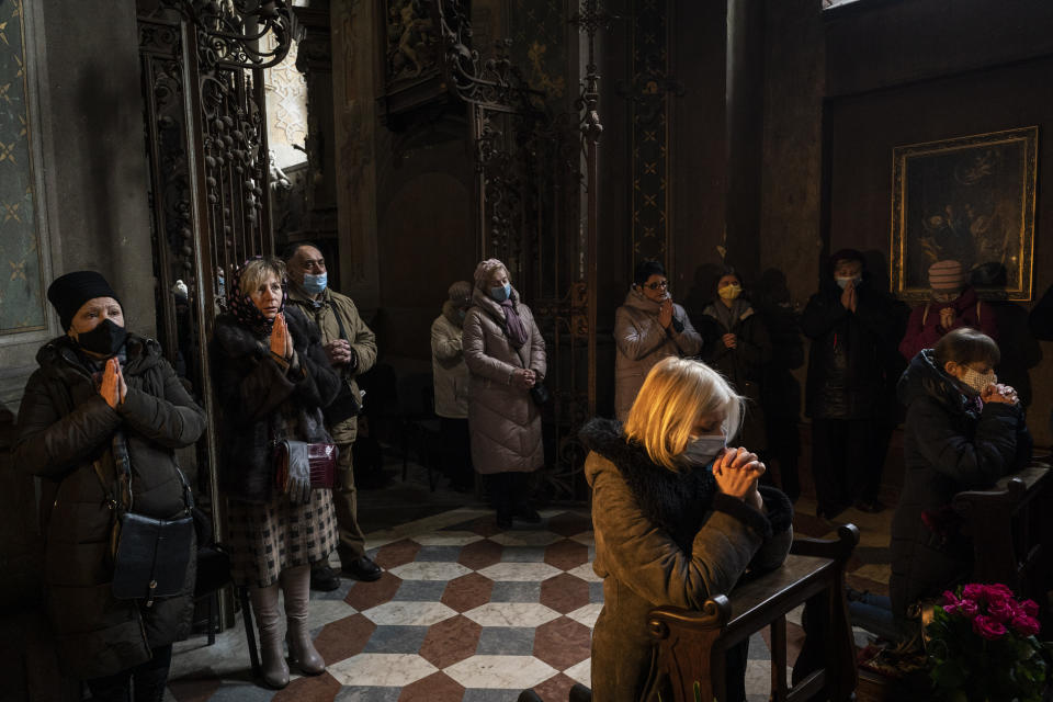 Christian worshipers attend a Sunday mass in the Saints Peter and Paul Garrison Church in Lviv, western Ukraine, Sunday, March 6, 2022. (AP Photo/Bernat Armangue)