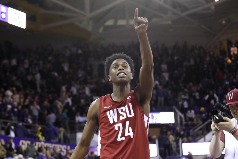 Washington State's Noah Williams points toward the stands after Washington State defeated Washington 78-74 in an NCAA college basketball game Friday, Feb. 28, 2020, in Seattle. (AP Photo/Elaine Thompson)