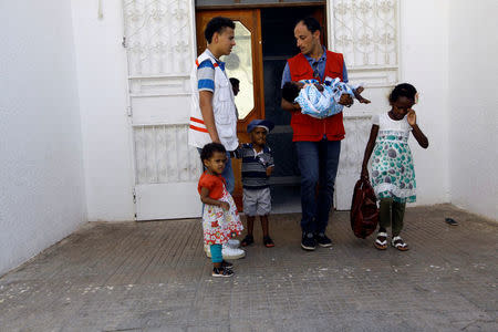 Members of Libyan Red Crescent are seen with the children of Sudanese Islamic State members who operated in Libya, before handing them over to Sudanese officials, in Misrata, Libya August 20, 2017. REUTERS/Ismail Zitouny