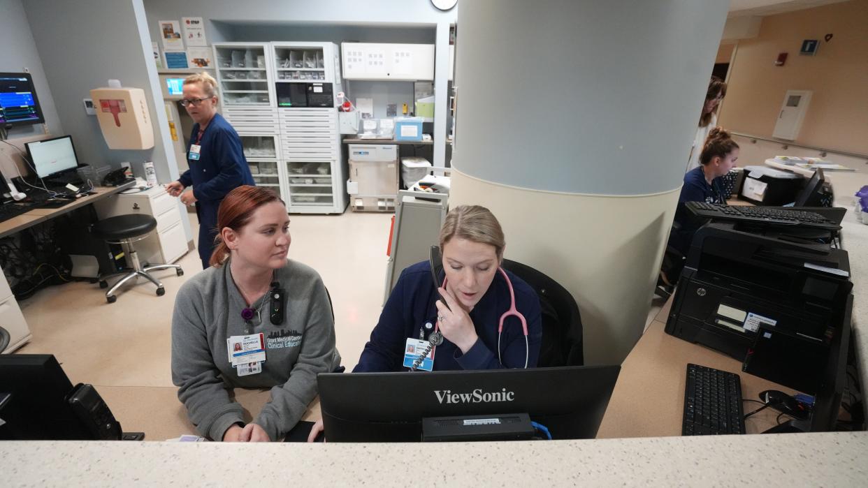 OhioHealth Grant Medical Center nurses Rochelle Brooks (left) and Sarah Bring work on the cardiac intermediate unit at the Downtown hospital. Bring is a Columbus State Community College nursing graduate in her first year of work at the hospital. Brooks is a clinical nurse educator and frequently helps Bring fill out her medical charts. Columbus State Community College President David Harrison and OhioHealth President and CEO Dr. Steve Markovich announced details Tuesday of a major joint investment in educating health care professionals.