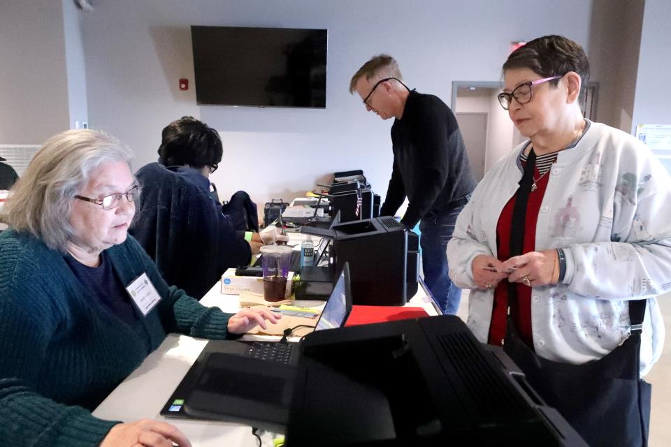 Nancy Bogle, left, gets Rita Wagonseller checked in before she votes early as Wes Wagonsell gets checked in by Katie Wilson in the background at Middle Tennessee Association of Realtors on Wednesday, Feb. 21, 2024.