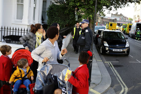 People speak with a police officer outside Parsons Green tube station in London, Britain September 15, 2017. REUTERS/Kevin Coombs