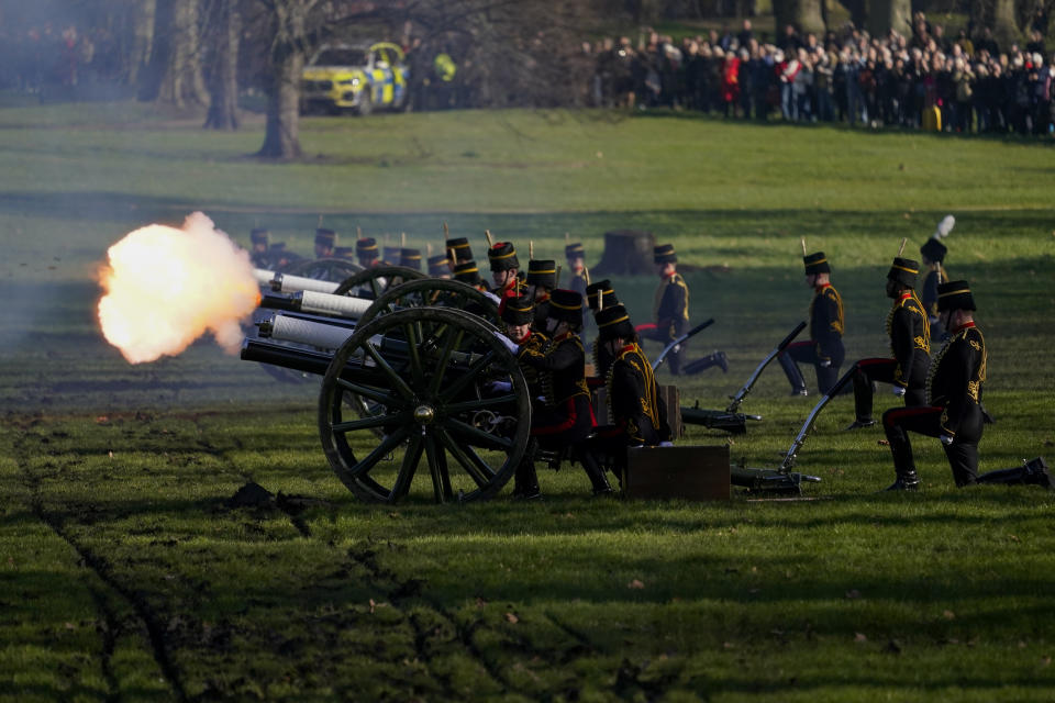 Fire shrouds the scene as The King's Troop Royal Horse Artillery fire gun salutes to mark the 70th anniversary of the accession to the throne of Britain's Queen Elizabeth, in Green Park beside Buckingham Palace, London, Monday, Feb. 7, 2022. Queen Elizabeth II acceded to the throne on the death of her father King George VI on Feb. 6, 1952. (AP Photo/Alberto Pezzali)