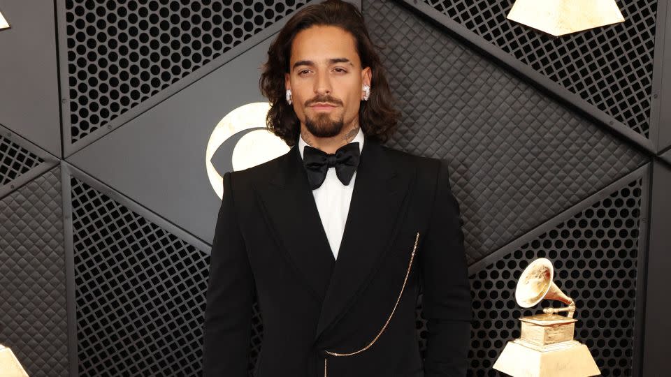 Colombian singer-songwriter Maluma wore a Dolce and Gabbana tuxedo with chain, diamond earrings and a rose gold and ruby watch by Jacob & Co. - Mario Anzuoni/Reuters