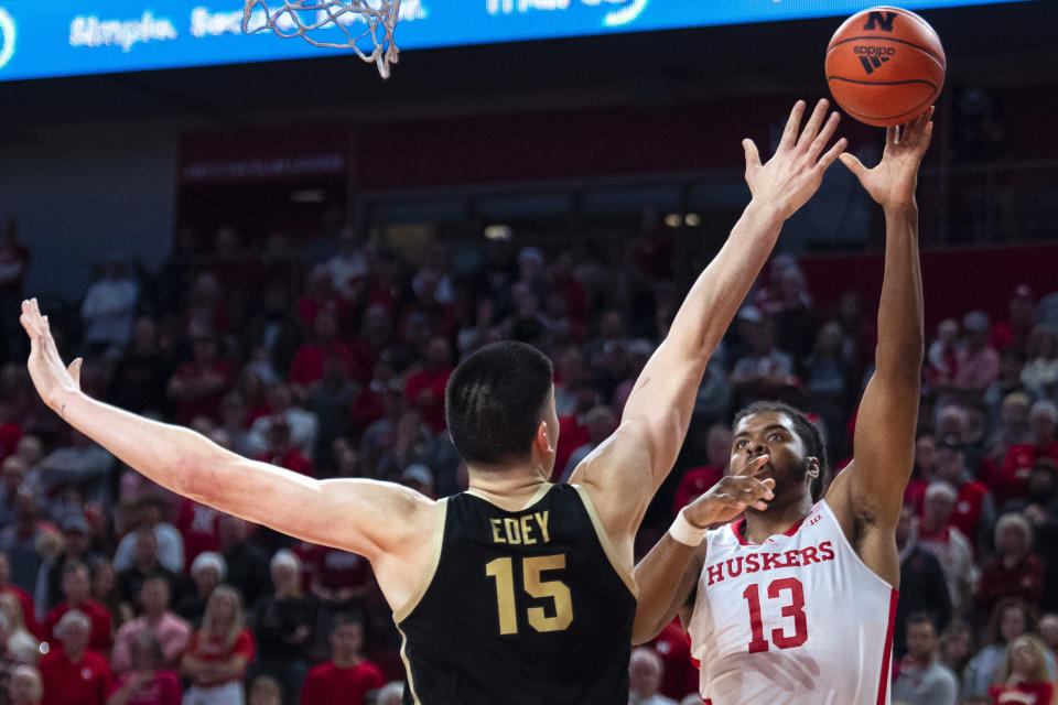 Purdue's Zach Edey (15) tries to block a layup by Nebraska's Derrik Walker (13) in the second half of an NCAA college basketball game Saturday, Dec. 10, 2022, in Lincoln, Neb. (Kenneth Ferriera/Lincoln Journal Star via AP)