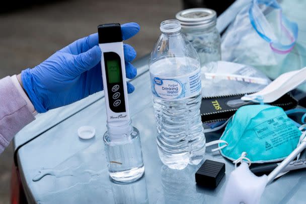 PHOTO: Olivia Holley, 22, and Taylor Gulish, 22, test the pH and the total dissolved solids (TDS) of the water from Leslie Run creek on February 25, 2023 in East Palestine, Ohio. (Michael Swensen/Getty Images)