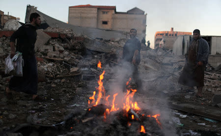 Palestinians inspect the scene of an Israeli air strike on a building in Gaza City October 27, 2018. REUTERS/Mohammed Salem