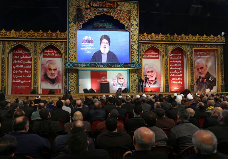 Lebanon's Hezbollah leader Sayyed Hassan Nasrallah addresses his supporters via a screen during a funeral ceremony rally to mourn Qassem Soleimani, head of the elite Quds Force, who was killed in an air strike at Baghdad airport, in Beirut's suburb