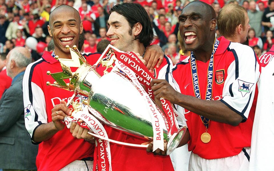 Thierry Henry (left), Robert Pires (centre) and Sol Campbell (right) celebrate with the trophy