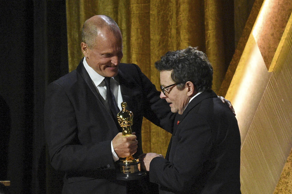 Michael J. Fox, right, accepts the Jean Hersholt Humanitarian Award from Woody Harrelson during the Governors Awards on Saturday, Nov. 19, 2022, at Fairmont Century Plaza in Los Angeles. (Photo by Richard Shotwell/Invision/AP)