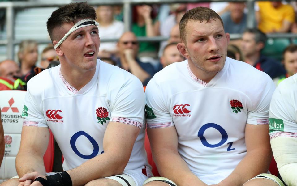 Tom Curry (L) and Sam Underhill of England watch from the substitute bench during the Quilter International match between England and Ireland at Twickenham Stadium on August 24, 2019 in London, England