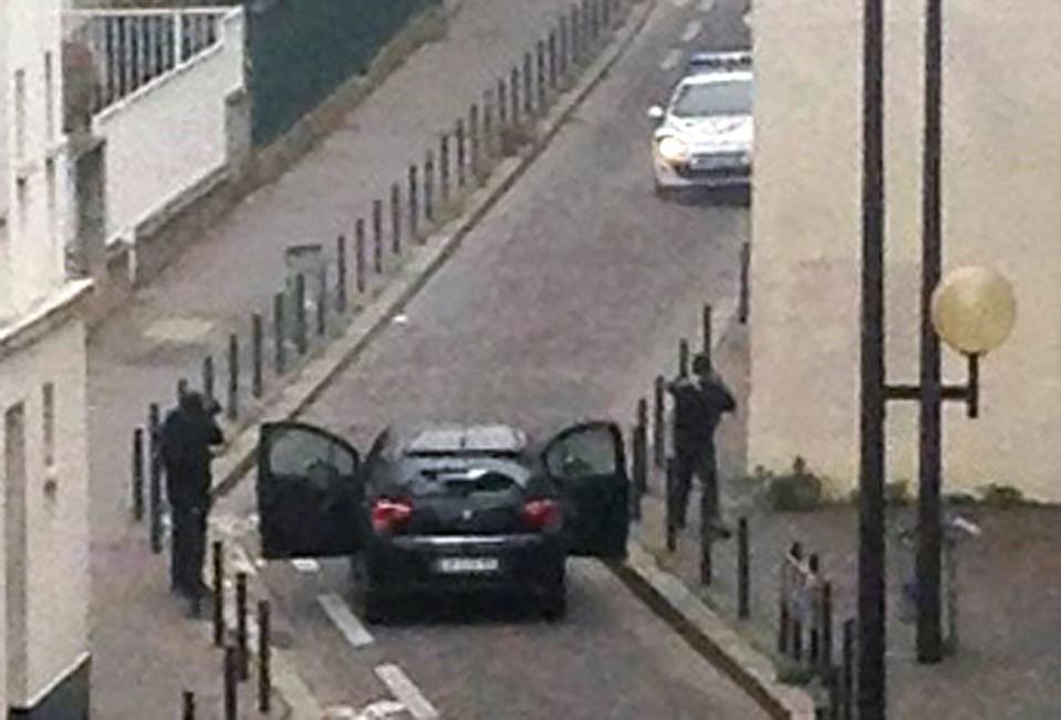 <div class="inline-image__caption"><p>Armed gunmen face police officers near the offices of the French satirical newspaper Charlie Hebdo in Paris on January 7, 2015, during an attack on the offices of the newspaper which left eleven dead, including two police officers, according to sources close to the investigation. </p></div> <div class="inline-image__credit">Anne Gelbard/Getty</div>