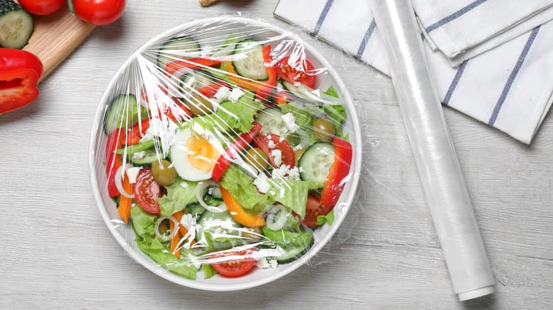 Salad bowl covered with cling wrap