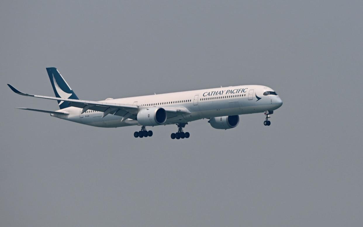 A Cathay Pacific passenger plane prepares to land at Hong Kong's international airport on March 13, 2019 - AFP