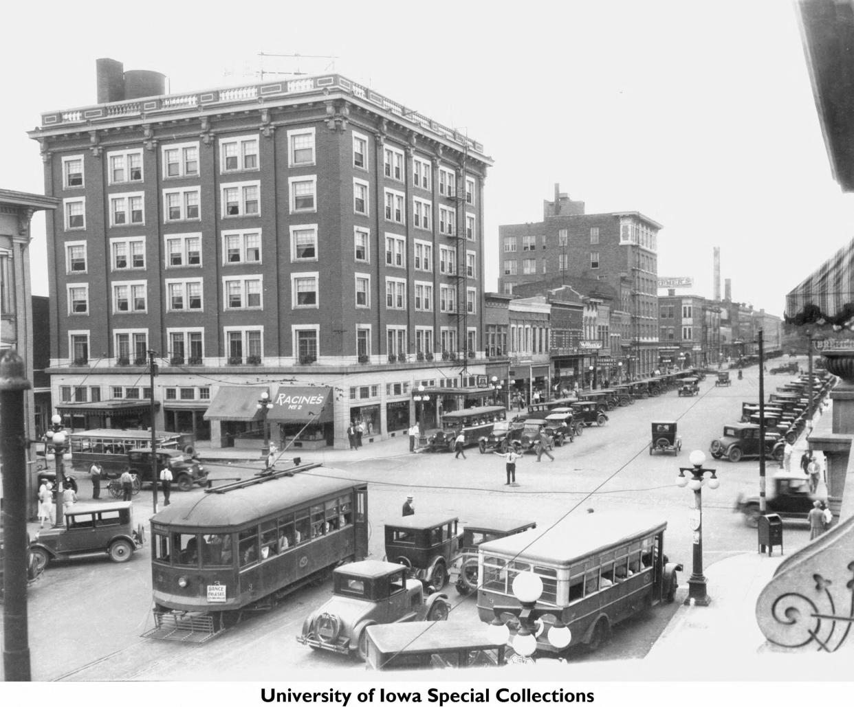 You can see three modes of early transportation – cars, busses, and a trolley -- in this 1920s vintage photo looking west on Washington Street toward the historic Jefferson Hotel in a thriving downtown Iowa City.