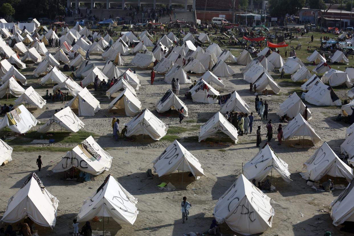 Temporary housing is constructed for flood victims, in Larkana District, of Sindh, Pakistan, Thursday, Sept. 8, 2022. The unprecedented deluge, which began in mid-June, has triggered landslides and collapsed houses, killing over 1,350 people and leaving over 600,000 homeless in Pakistan. (AP Photo/Fareed Khan)