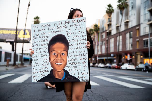 A person holds a sign with Elijah McClain's last words at a candlelight vigil on Aug. 24, 2020, the one-year anniversary of his death at the hands of police and paramedics. (Photo: Rich Fury via Getty Images)