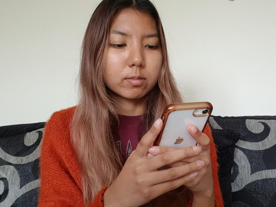 A picture of the author using her phone.