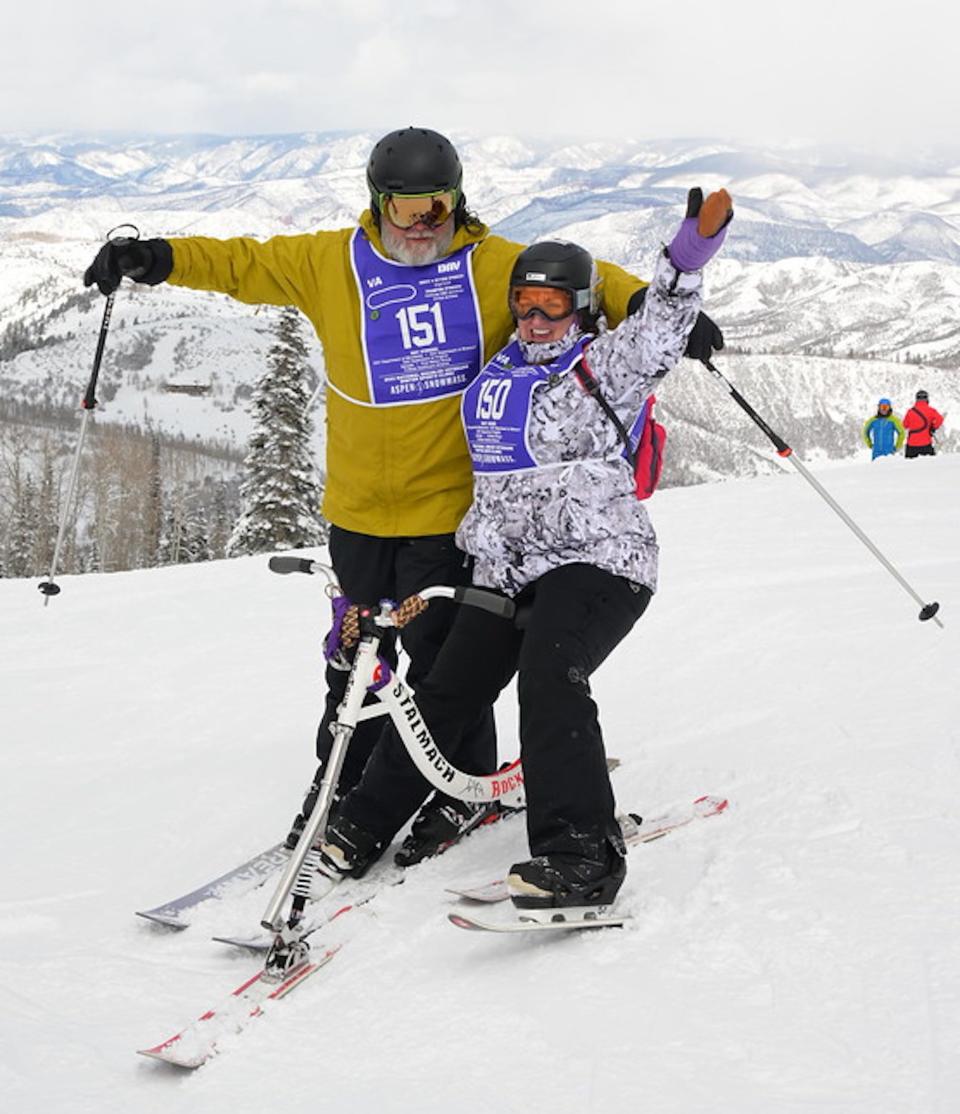 Roland Cagnon and his wife, Joyce, both medically retired from the military, took up adaptive skiing to continue enjoying a sport they loved. Joyce is seen sitting on a ski-bike, which allows her to sit down while skiing, using the handlebars to steer.