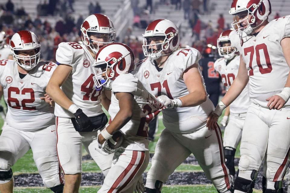 Owasso's Ryker Haff (71) celebrates a J'Kharri Thomas TD in the 2022 Class 6A-I state semifinals against Tulsa Union.