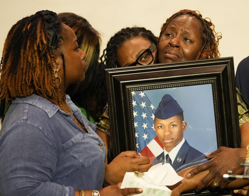 CORRECTS SERVICE BRANCH TO U.S. AIR FORCE INSTEAD OF U.S. NAVY - Chantemekki Fortson, mother of Roger Fortson, a U.S. Air Force senior airman, is comforted by family as she holds a photo of her son during a news conference regarding his death, along with family and Attorney Ben Crump, in Fort Walton Beach, Fla. Fortson was shot and killed by police in his apartment, May 3, 2024. (AP Photo/Gerald Herbert)