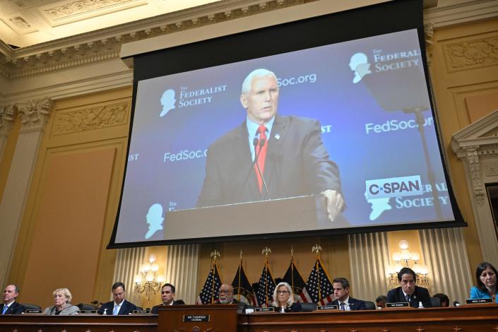 An image of former Vice President Mike Pence is projected above the members of the January 6 committee during a hearing.