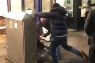 A man kicks another in the head during a mass brawl on a train platform (MazMedia TV)