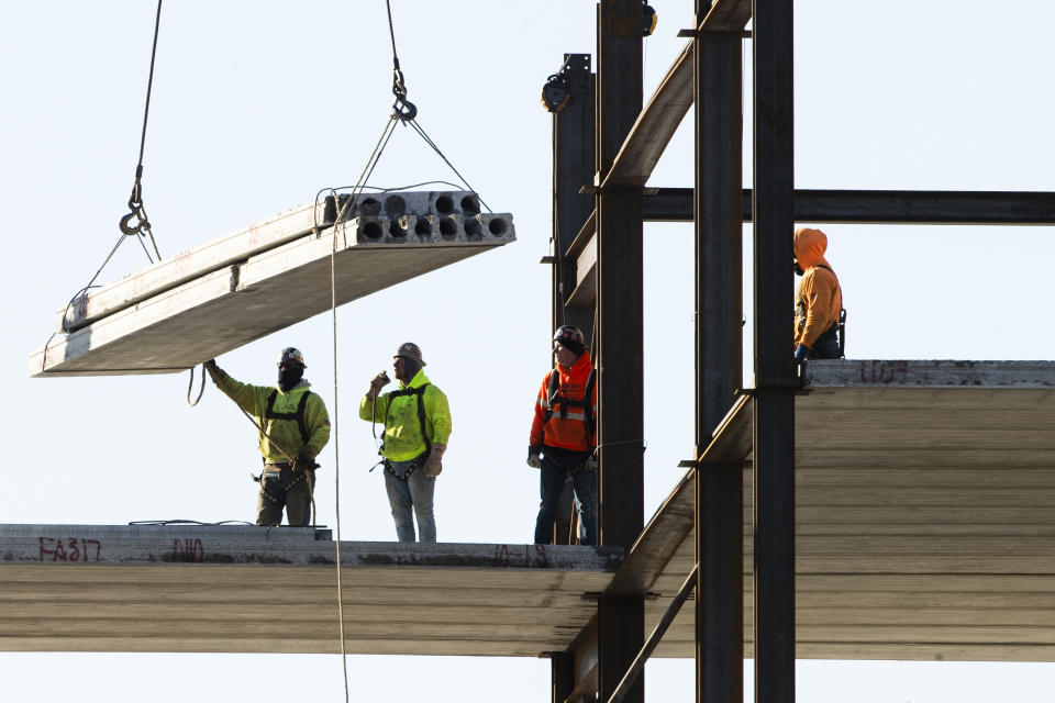 FILE - In this Dec. 3, 2019, file photo, workers erect a building under construction in Philadelphia. U.S. construction spending fell again in June 2020, the fourth straight decline as the coronavirus outbreak continues to wreak havoc on the economy. (AP Photo/Matt Rourke, File)