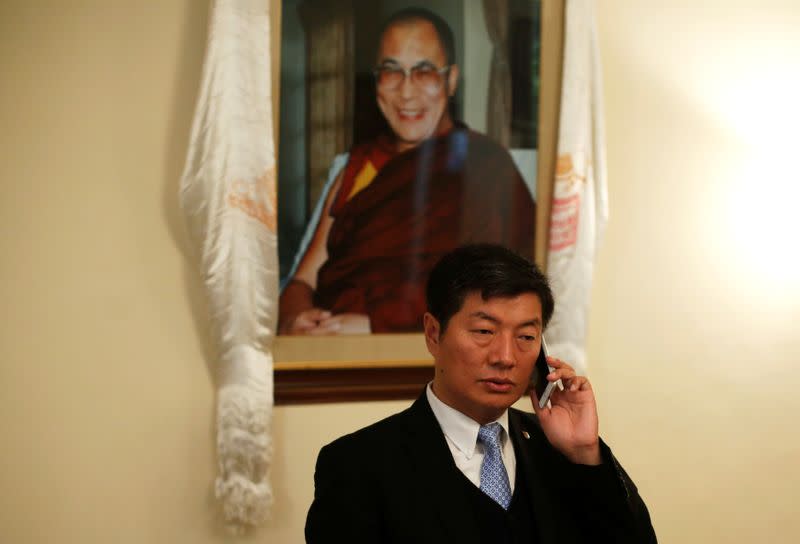 Lobsang Sangay, PM of the Tibetan government-in-exile, speaks on his mobile phone before start of an interview with Reuters in New Delhi