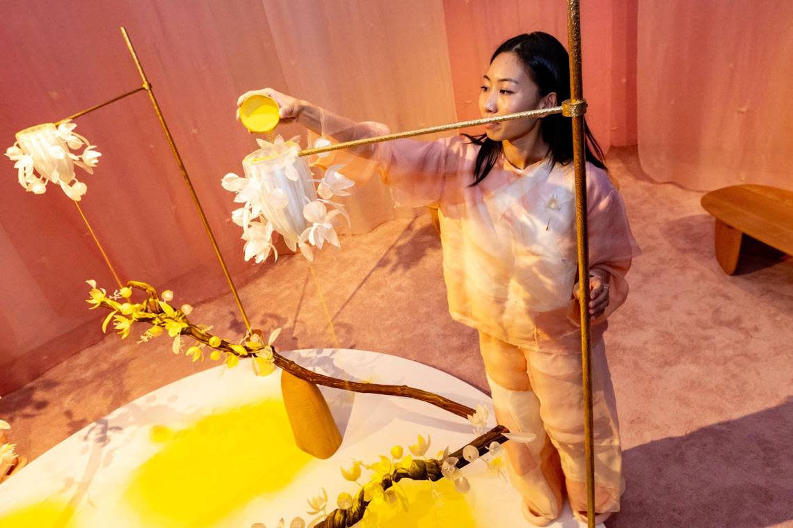 Art team member Alyssa Tang, 27, interacts with the Maison Perrier-Jouët exhibit highlighting Mexican artist Fernando Laposse and his artwork titled ‘‘The Pollination Dance”, inspired by the flower. The piece was on display at Design Miami in Miami Beach.