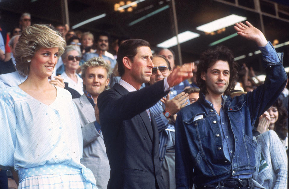 Princess Diana, left, and Prince Charles attend the Live Aid concert as they acknowledge the crowd with event organizer Bob Geldof, right, at London's Wembley Stadium, England, July 13, 1985.  (AP Photo/Joe Schaber)