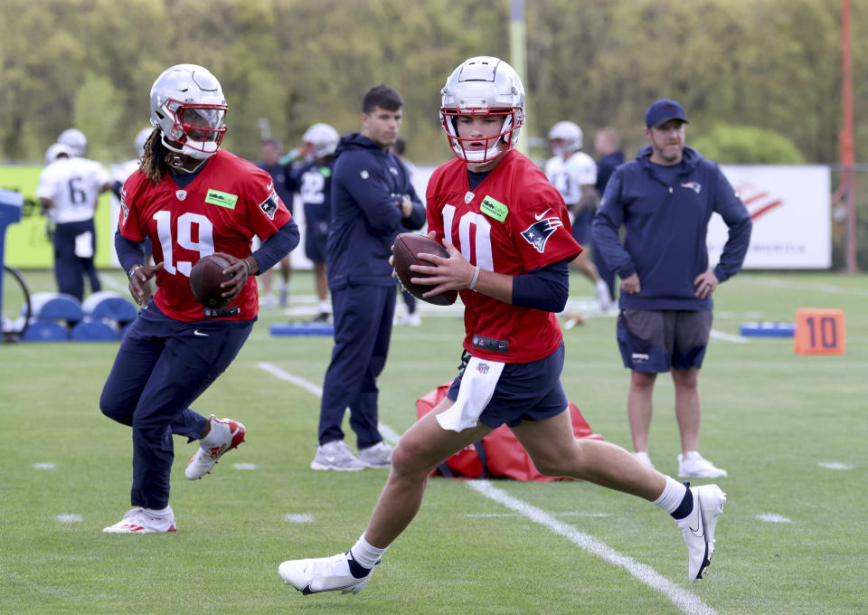 New England Patriots sixth round quarterback draft pick Joe Milton, III (19) and first round quarterback draft pick Drake Maye (10) run passing drills during the NFL football team's rookie minicamp Saturday, May 11, 2024, in Foxborough, Mass. (AP Photo/Mark Stockwell)