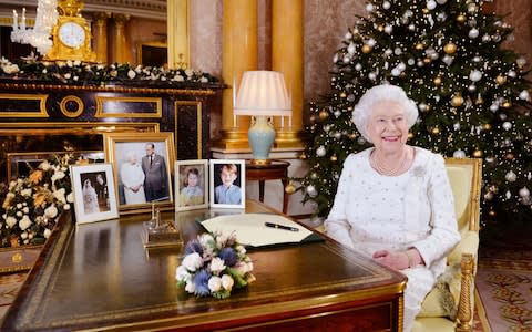 Pictures of some of the Queen's family members were on display as she delivered her Christmas message - Credit: John Stillwell /PA