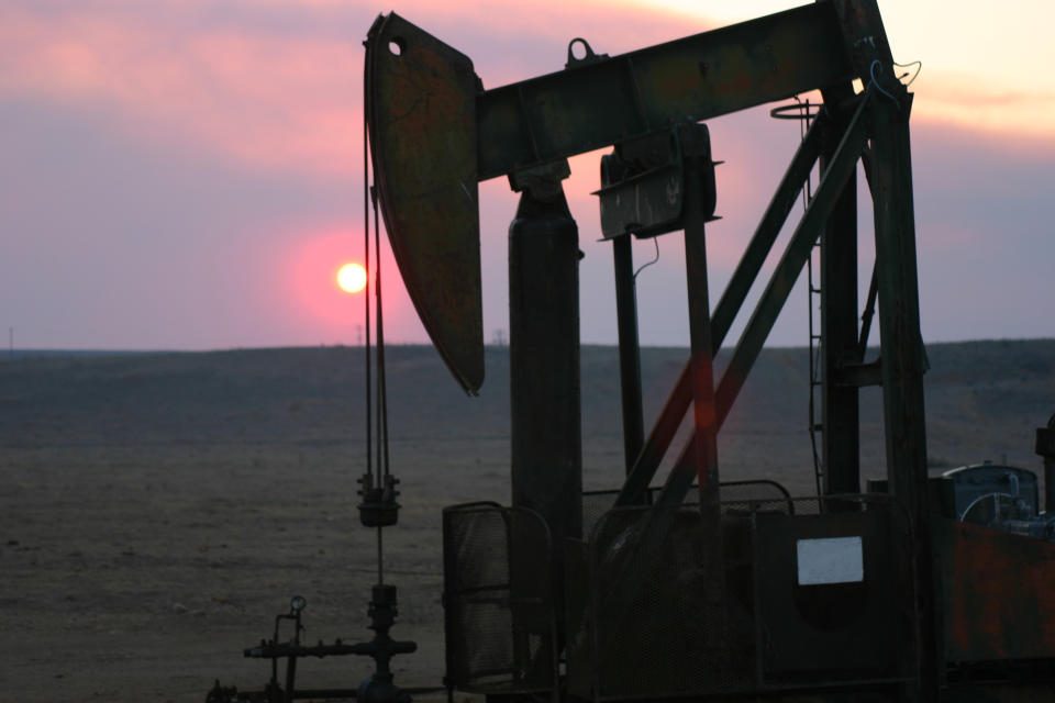 Oil pump with the evening sun going down.