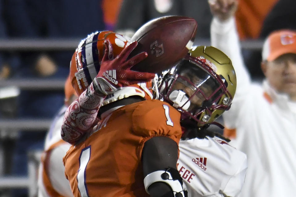 FILE - Boston College wide receiver Dino Tomlin, right, gets wrapped up around Clemson's Andrew Mukuba on an incomplete pass during the second half of an NCAA college football game Oct. 8, 2022, in Boston. Boston College opens their season at home against Northern Illinois on Sept. 2.(AP Photo/Mark Stockwell, File)