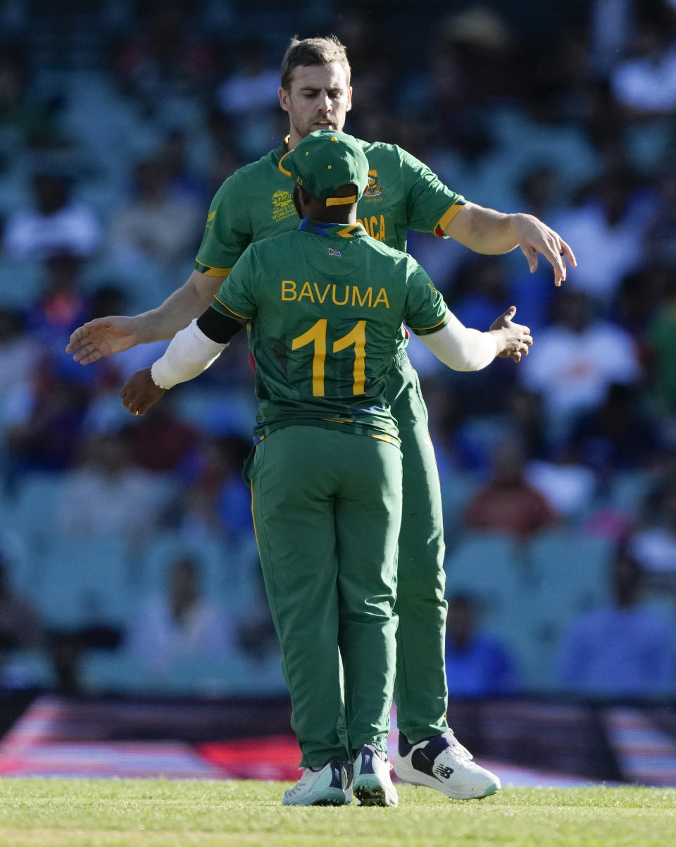 South Africa's captain Temba Bavuma congratulates bowler Anrich Nortje after taking four wickets in their T20 World Cup cricket match against Bangladesh in Sydney, Australia, Thursday, Oct. 27, 2022. (AP Photo/Rick Rycroft)