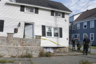 Fire inspectors talk to the residents of a home that was blown off its foundation on Kingston Street in Lawrence, Mass., Friday, Sept. 14, 2018. Multiple houses were damaged Thursday afternoon from gas explosions and fires triggered by a problem with a gas line that feeds homes in several communities north of Boston. (AP Photo/Mary Schwalm)