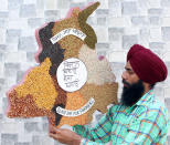 City-based artist Gurpreet Singh shows artwork dedicated to farmers who are agitating against the farm bills, on September 25, 2020 in Amritsar, India. Singh has made a map of Punjab, on which various food grains and pulses that are produced by the farmers, are displayed, besides slogans. The two bills - the Farmers (Empowerment and Protection) Agreement on Price Assurance and Farm Services Bill, 2020 and the Farming Produce Trade and Commerce (Promotion and Facilitation) Bill, 2020 - were passed by the Rajya Sabha despite uproar and strong protest by the Opposition parties in the house. (Photo by Sameer Sehgal/Hindustan Times via Getty Images)