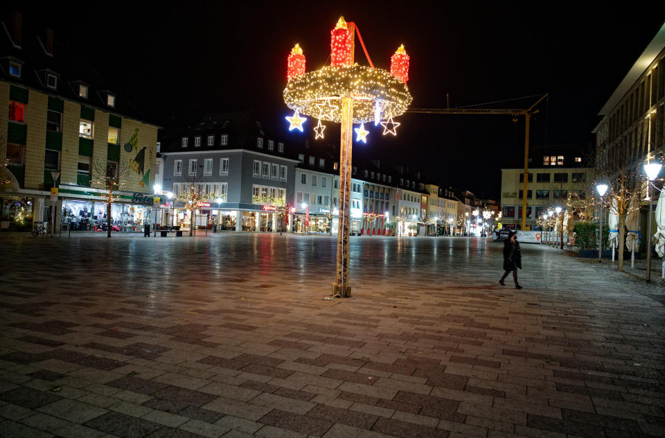 The city centre and pedestrian zone are almost deserted in Dueren, Germany, Monday, Dec. 14, 2020. Due to the night-time exit restriction between 9 p.m. and 5 a.m., the people of in the city are only allowed to leave their apartment for important reasons. (Henning Kaiser/dpa via AP)