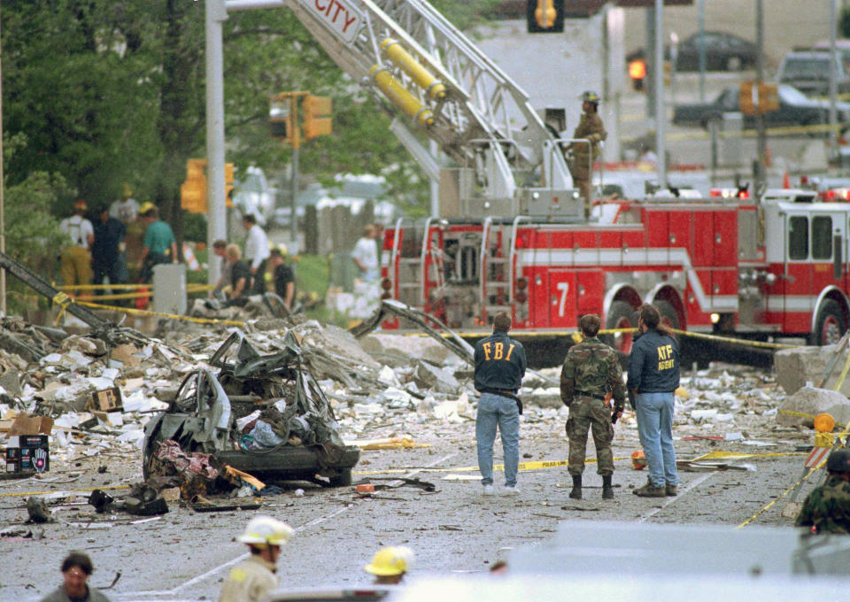 FILE - In this April 19, 1995, file photo, Federal Alcohol, Tobacco and Firearms agents and FBI agents survey the damage to the Alfred P. Murrah Federal Building, following a car bomb blast in Oklahoma City, Okla. (AP Photo/Rick Bowmer, File)