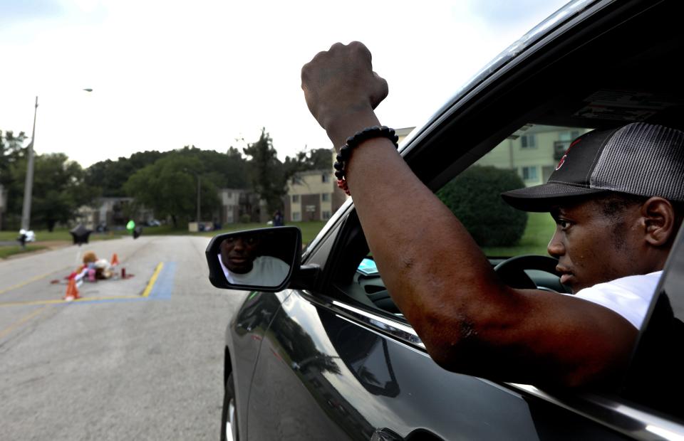 Protester Joseph Miles, who visits the street memorial for Michael Brown at the Pleasant View Gardens Apartments, shouts "Mike Brown forever," on the seventh anniversary of the police shooting of Brown on Monday, Aug. 9, 2021, in Ferguson, Mo. (Laurie Skrivan/St. Louis Post-Dispatch via AP)