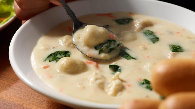 Bowl of creamy soup with gnocchi and kale