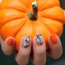 <a href="https://jinsoon.com/content/fancybox/Tutorials/Halloween.jpg" rel="nofollow noopener" target="_blank" data-ylk="slk:This manicure;elm:context_link;itc:0;sec:content-canvas" class="link ">This manicure</a> conveys a clear love of Halloween without screaming it like a banshee. After a perfect pumpkin-orange base in the JinSoon shade Enflammee. While it's still wet, the shades Obsidian and Doux were added to two accent nails and gently dragged with a striping brush to create ghostly swirls.