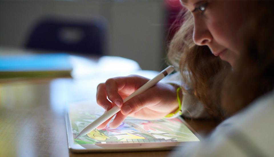This undated photo provided by Apple shows a student using a new 9.7-inch iPad with Apple Pencil support. In preparing for high school, the right supplies matter. Most high school kids will need some kind of laptop or tablet. Each school is different, so check with a school counselor about policies and recommendations, says Ellen Delap, a professional organizer based in Texas, who runs Professional-Organizer.com. (Apple via AP)