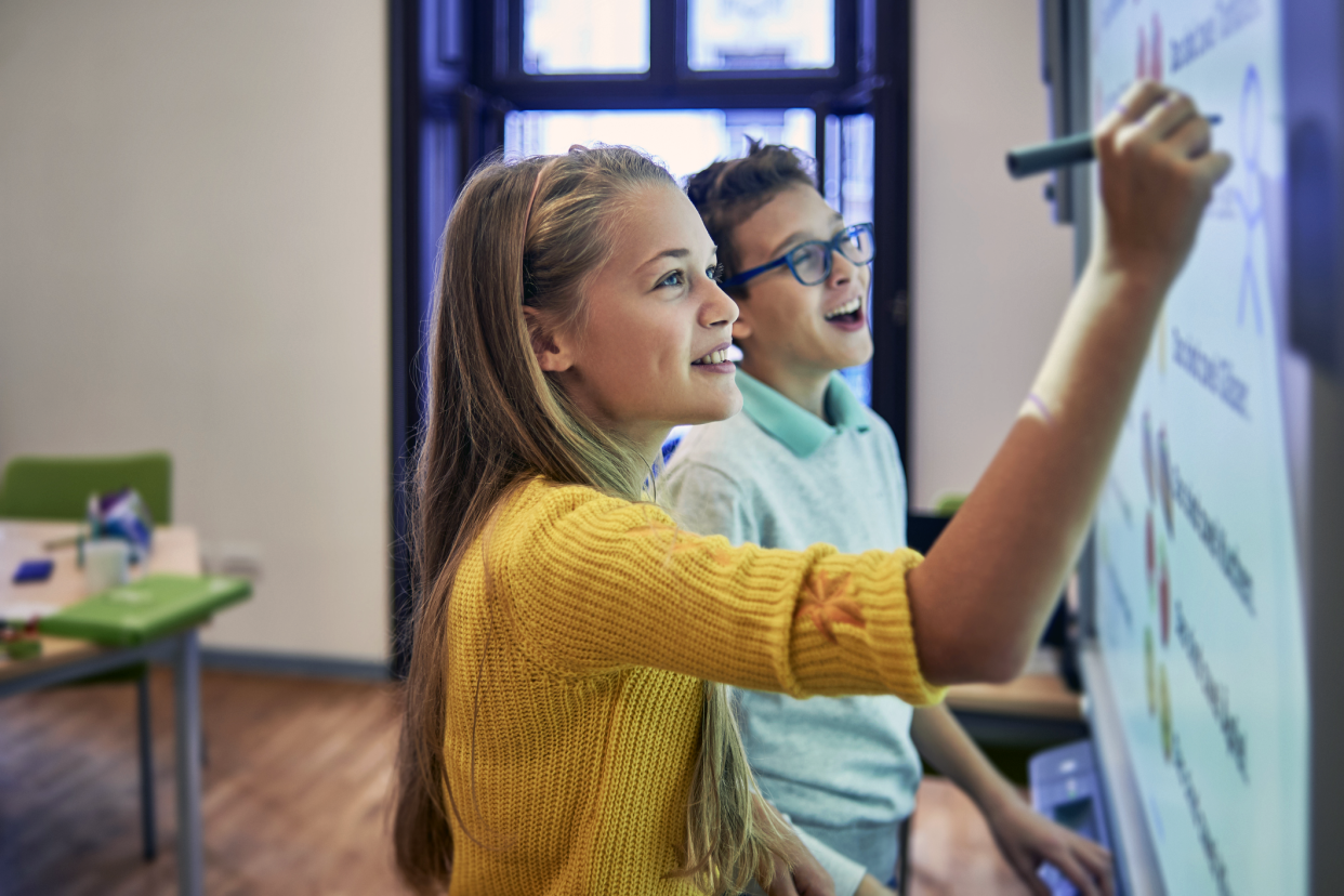 kids writing on smart board