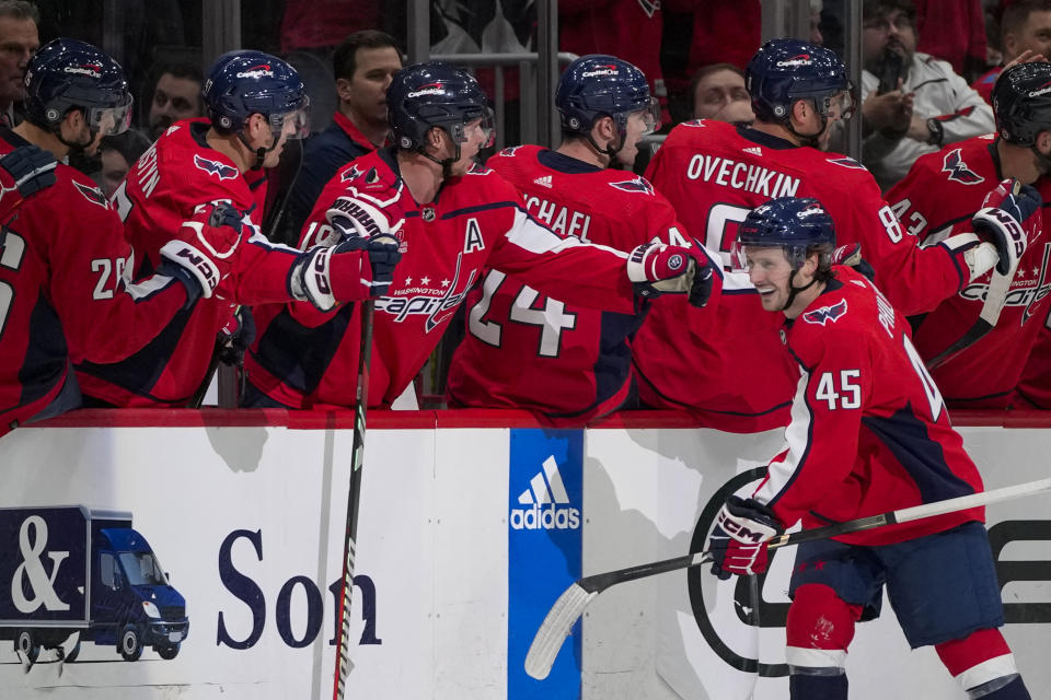 Washington Capitals center Matthew Phillips (45) celebrates his goal with his teammates in the second period of an NHL hockey game against the Calgary Flames, Monday, Oct. 16, 2023, in Washington. (AP Photo/Alex Brandon)